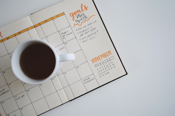 Planner and pen on a clean desk for time blocking