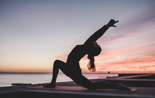 Woman in morning stretch pose in a sunlit room